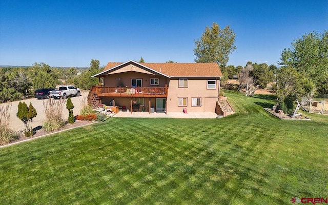 rear view of property with a wooden deck, a patio area, and a lawn