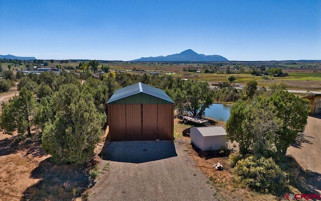 bird's eye view with a water and mountain view