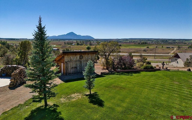 drone / aerial view featuring a mountain view and a rural view