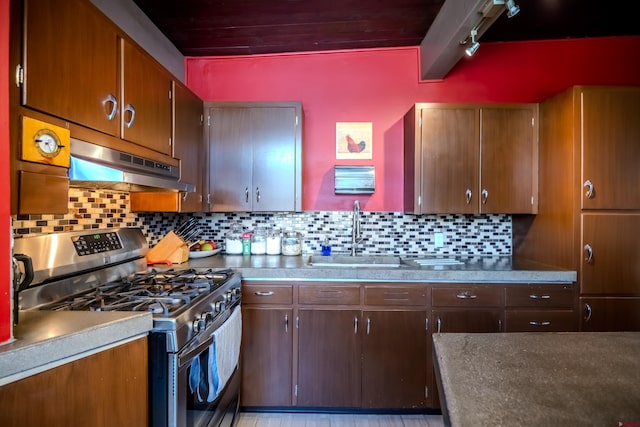 kitchen with backsplash, sink, and stainless steel gas range