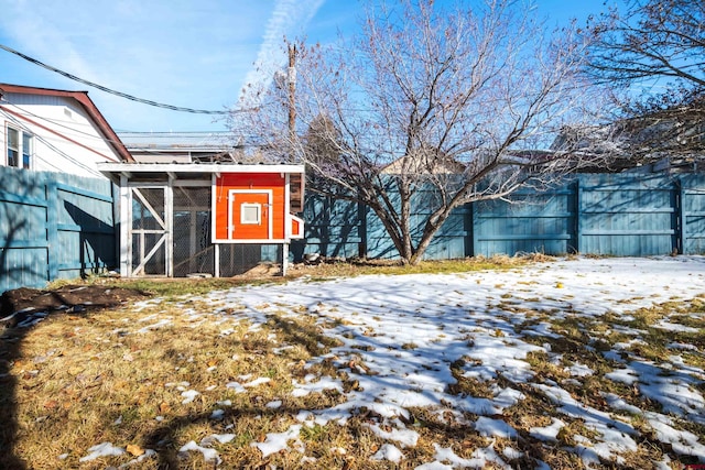 snowy yard with an outdoor structure