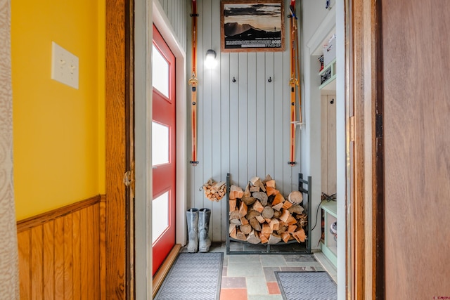 mudroom featuring wood walls