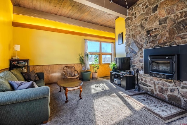 living room with wood ceiling, wooden walls, beamed ceiling, and dark carpet