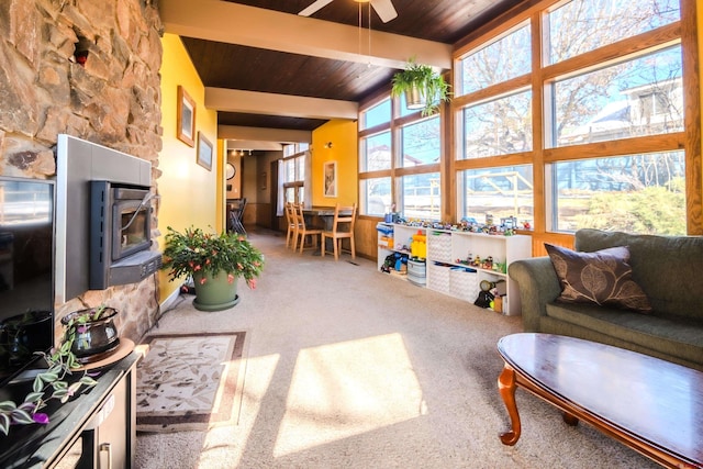 living room with carpet, ceiling fan, beam ceiling, and wood ceiling