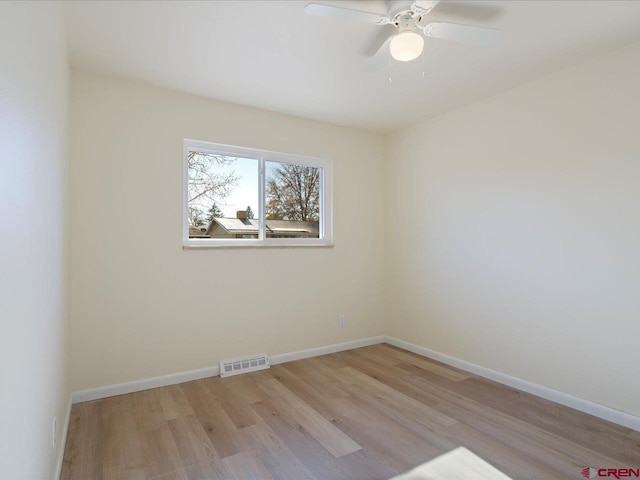 spare room with light hardwood / wood-style flooring and ceiling fan