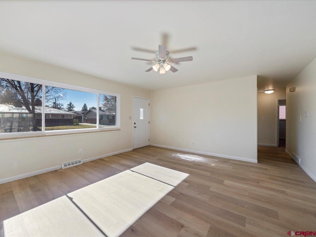 spare room with ceiling fan and wood-type flooring