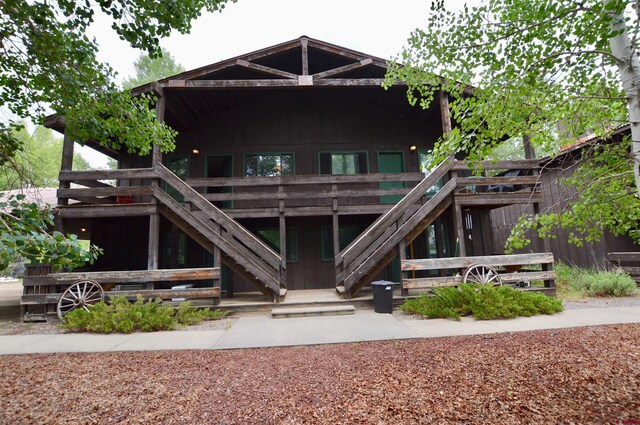 back of house featuring a wooden deck