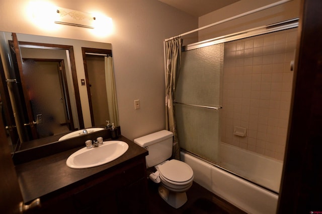 full bathroom with vanity, toilet, and bath / shower combo with glass door