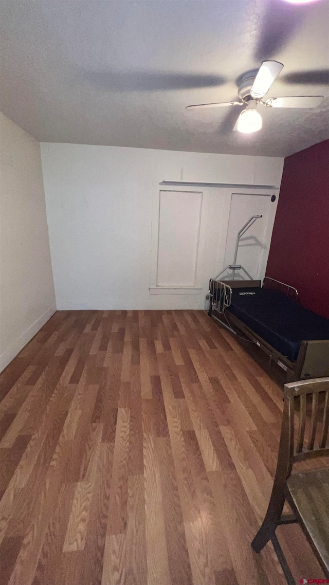 interior space featuring a textured ceiling, hardwood / wood-style flooring, and ceiling fan