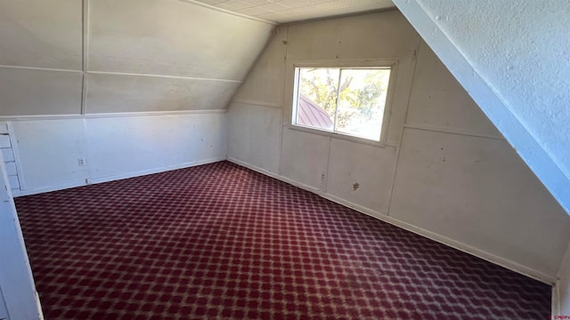 additional living space with carpet and vaulted ceiling