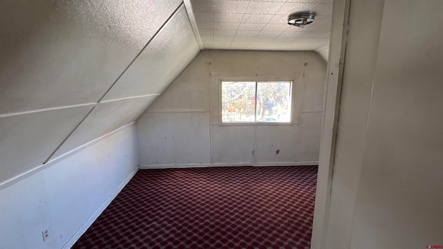 additional living space featuring lofted ceiling and carpet floors