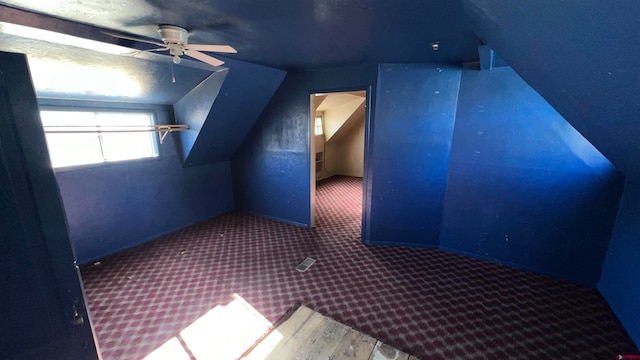 bonus room featuring carpet, a textured ceiling, ceiling fan, and lofted ceiling