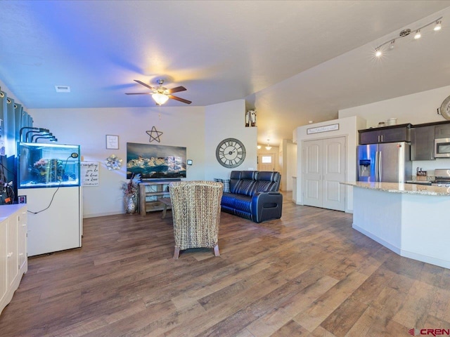 living room featuring dark hardwood / wood-style floors, ceiling fan, and lofted ceiling