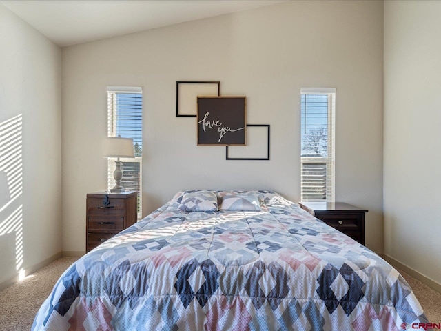 carpeted bedroom featuring lofted ceiling