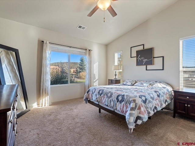 bedroom with ceiling fan, light colored carpet, and vaulted ceiling