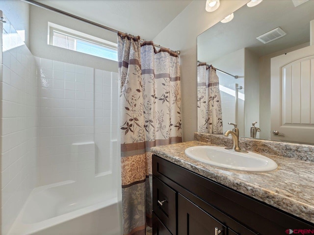 bathroom with shower / tub combo and vanity