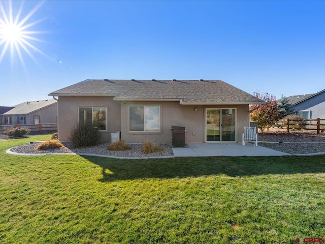 back of property featuring a lawn and a patio area