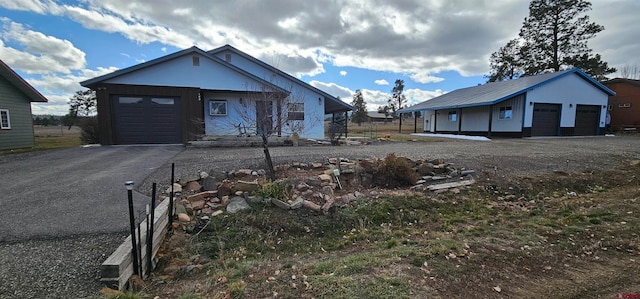 view of front of property with a garage and an outdoor structure