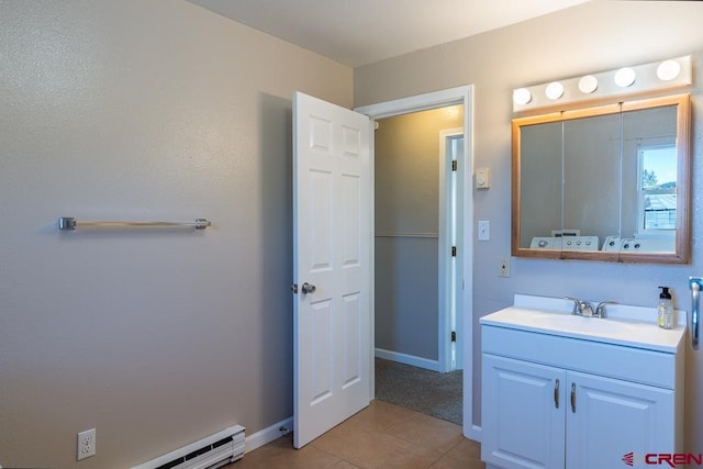 bathroom featuring tile patterned flooring, vanity, and baseboard heating