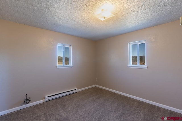 empty room with carpet, a textured ceiling, and baseboard heating