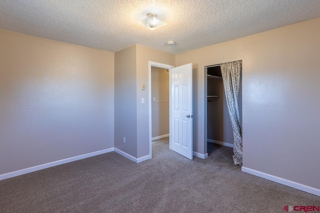 unfurnished bedroom with carpet and a textured ceiling