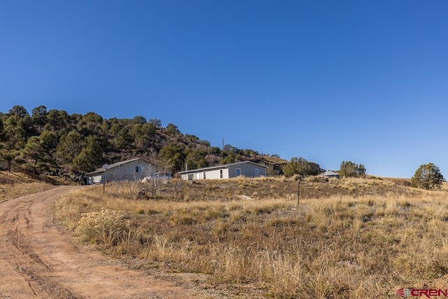 view of yard with a rural view