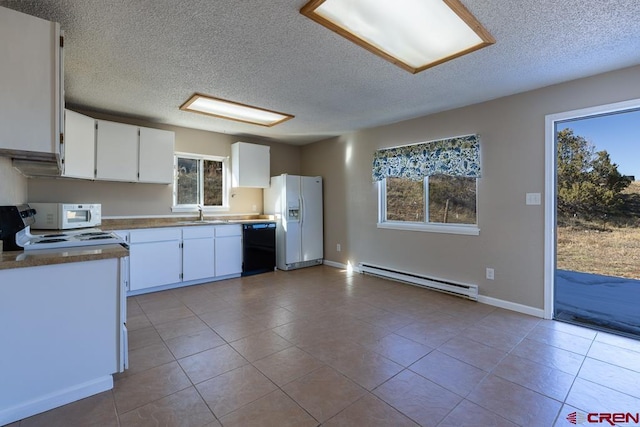 kitchen featuring white cabinetry, white appliances, a wealth of natural light, and a baseboard heating unit