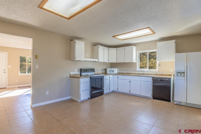 kitchen with white appliances, white cabinetry, a wealth of natural light, and sink