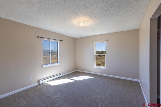 empty room with a textured ceiling, carpet floors, and baseboard heating