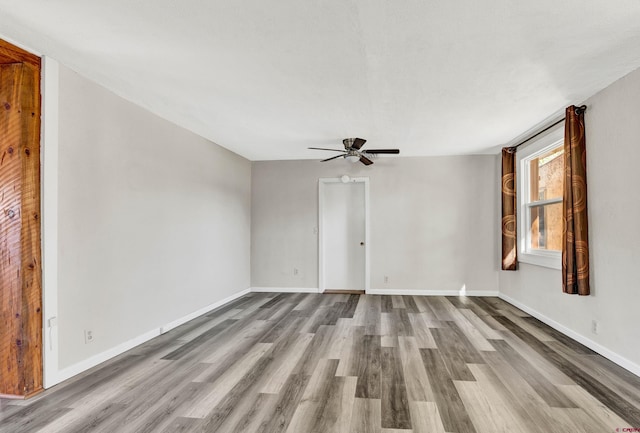 empty room with ceiling fan and light wood-type flooring