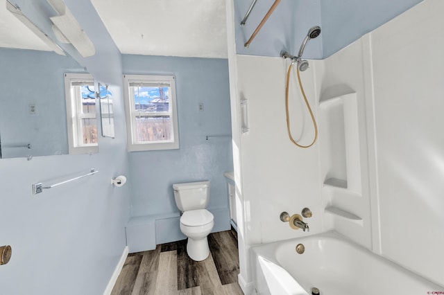 bathroom with wood-type flooring, toilet, and shower / bathtub combination