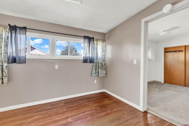 unfurnished room with wood-type flooring