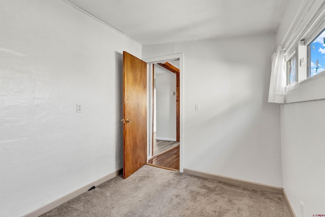 empty room featuring light carpet