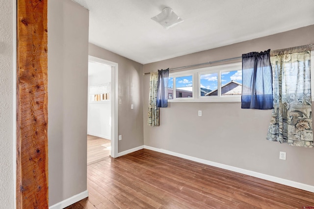 spare room with hardwood / wood-style floors