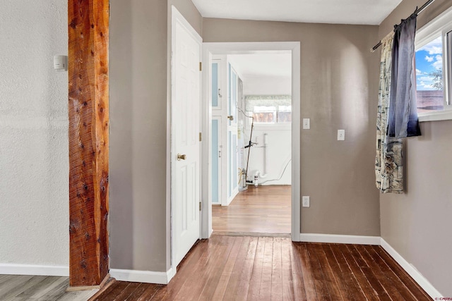 hall with wood-type flooring