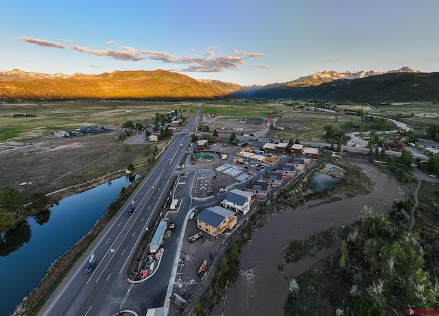 aerial view at dusk with a water and mountain view