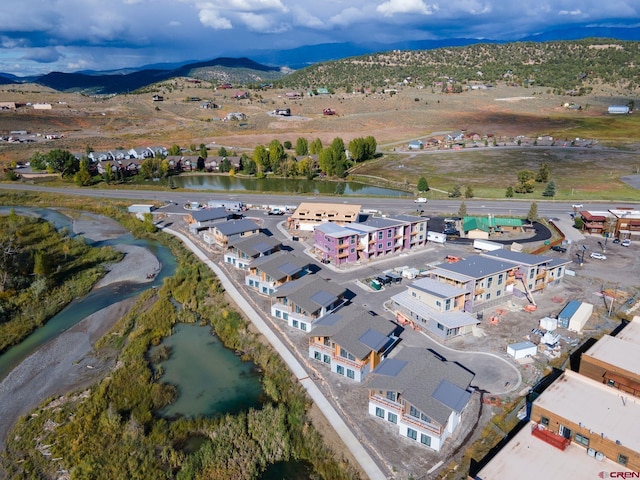 drone / aerial view featuring a water and mountain view