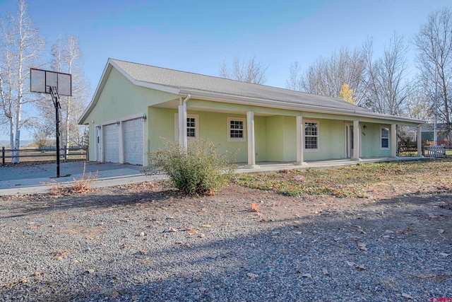 view of front of house featuring a porch and a garage