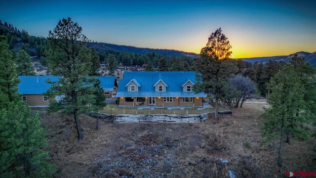 aerial view at dusk featuring a mountain view