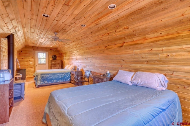 carpeted bedroom with vaulted ceiling, a wood stove, wooden walls, and wood ceiling