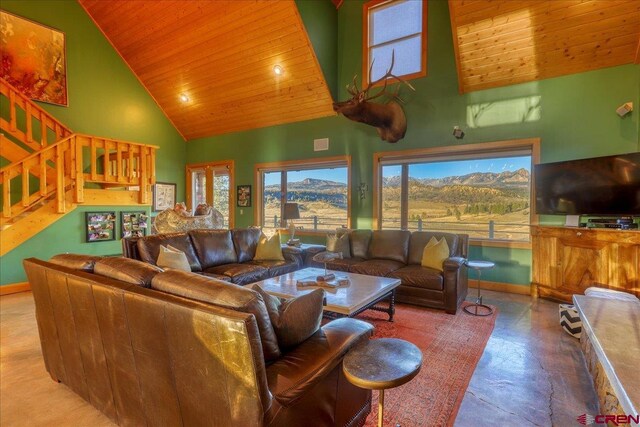 living room featuring high vaulted ceiling and wood ceiling