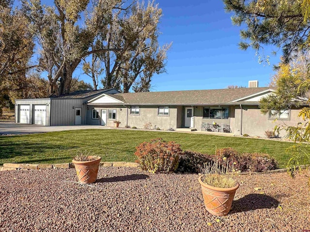 ranch-style house featuring a garage and a front lawn