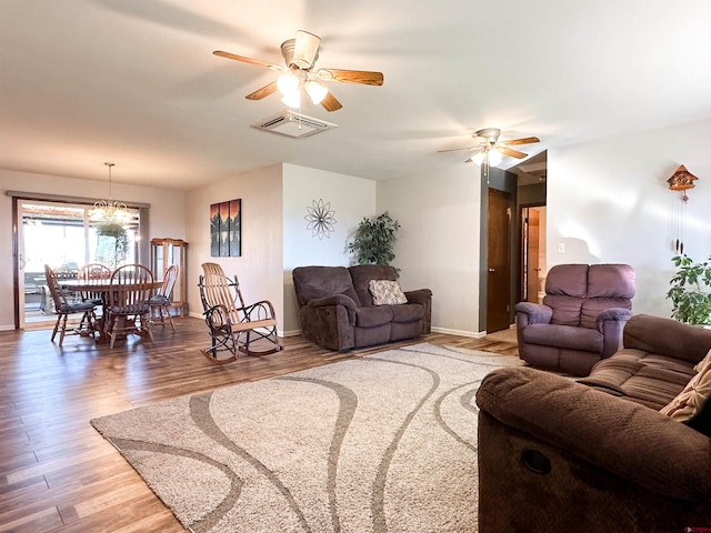 living room featuring hardwood / wood-style floors and ceiling fan