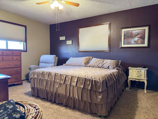 bedroom with a textured ceiling, light colored carpet, and ceiling fan