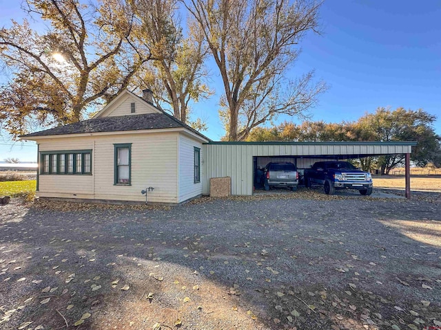 view of side of property with a carport