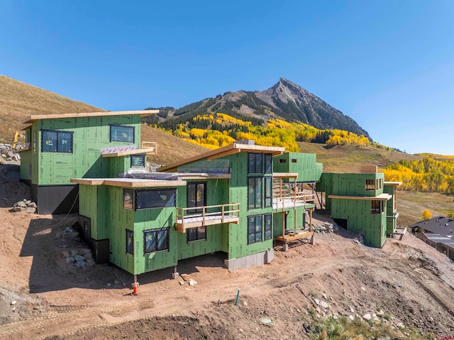 back of property featuring a mountain view