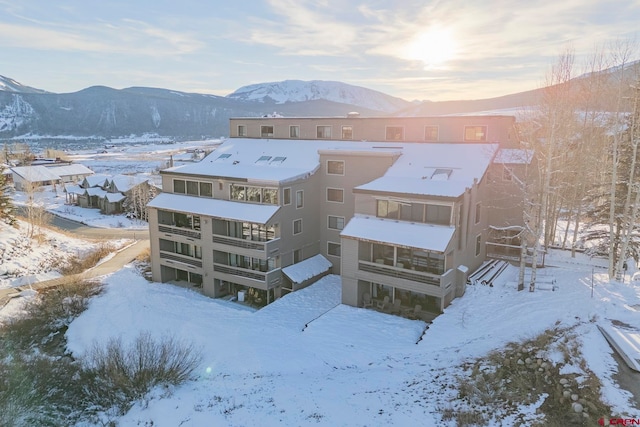 snowy aerial view with a mountain view