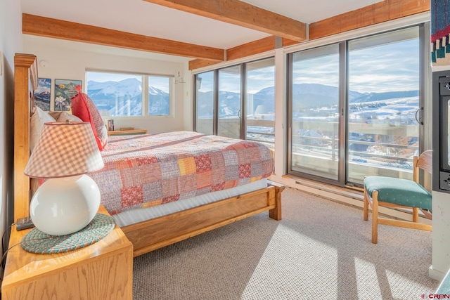 carpeted bedroom with a mountain view and beam ceiling