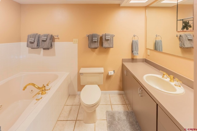 bathroom featuring tile patterned floors, vanity, toilet, and tiled tub