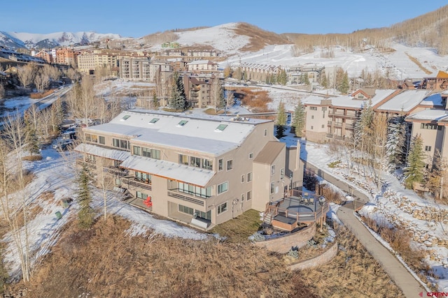 snowy aerial view featuring a mountain view